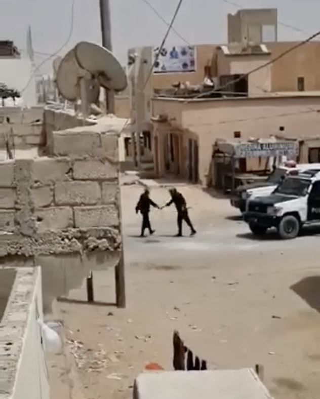 Mauritanian police high five each other after throwing a grenade into a home and striking some people.