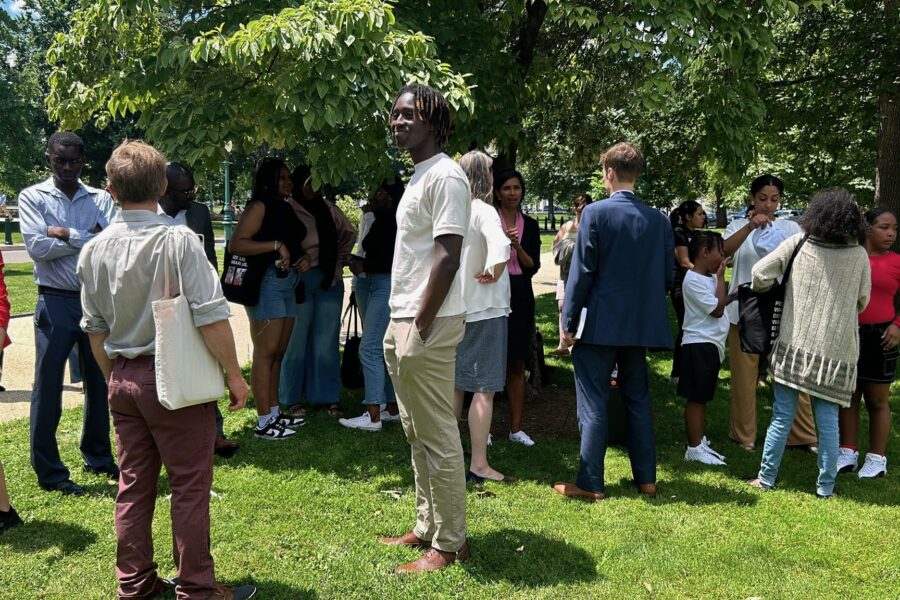 A crowd gathers to hear from people whose loved ones were deported outside of the US Capitol.