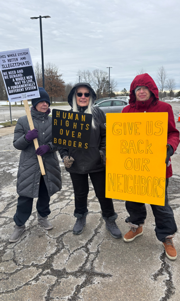 Three women holding signs